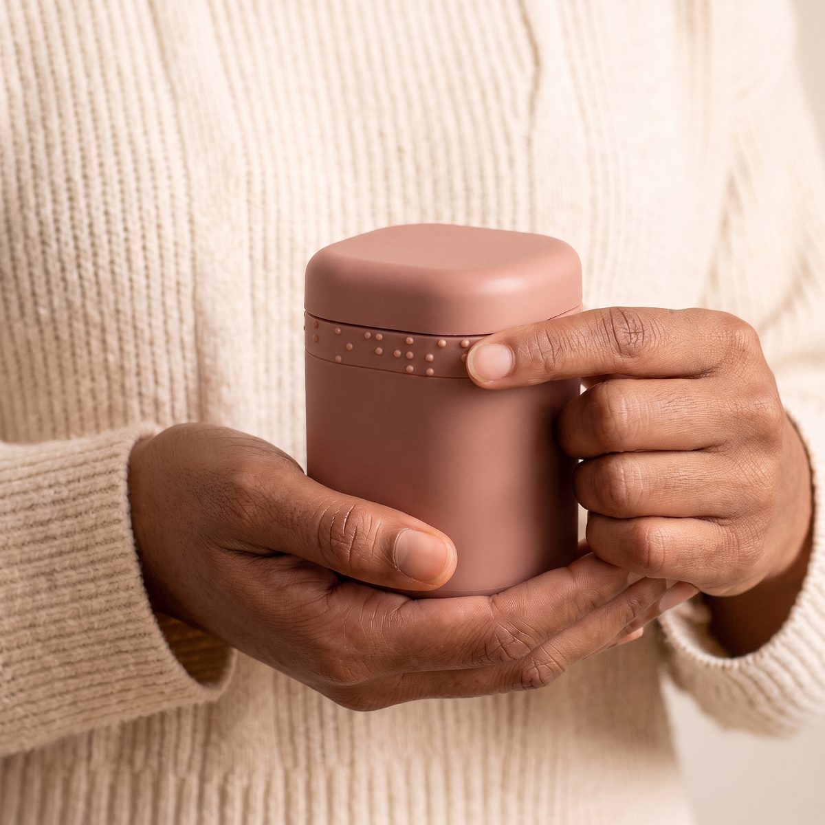 Index finger reading the braille label on a capsule held in hand